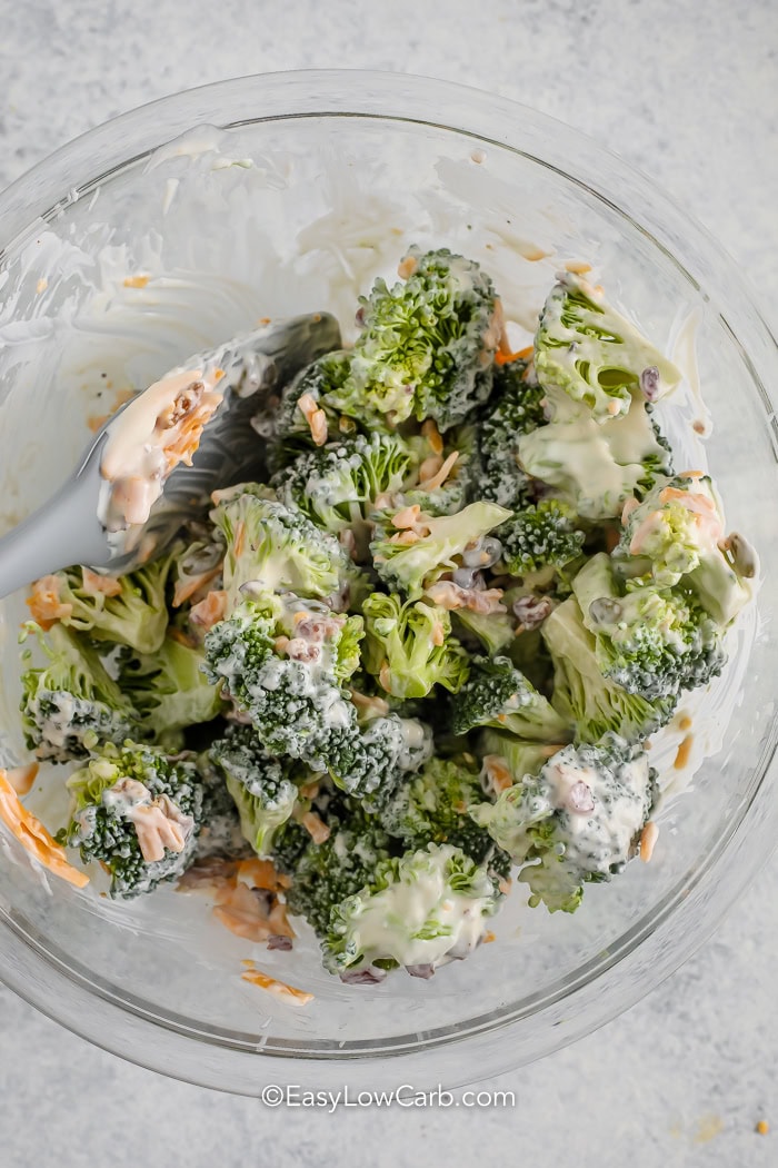 keto broccoli salad being mixed in a bowl