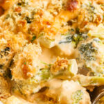 taking a spoonful of Broccoli au Gratin with writing