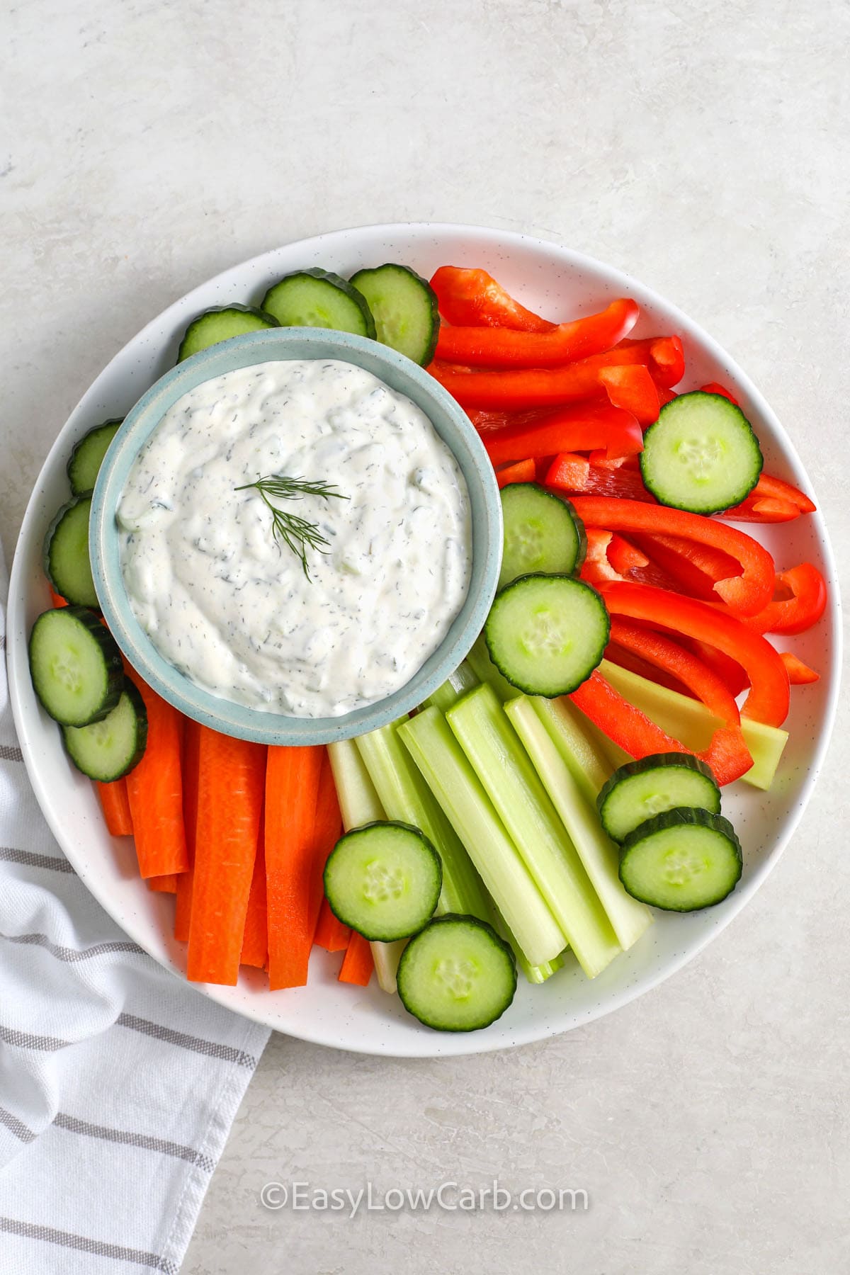 Cucumber Dip with cucumbers , celery , carrots and red peppers.