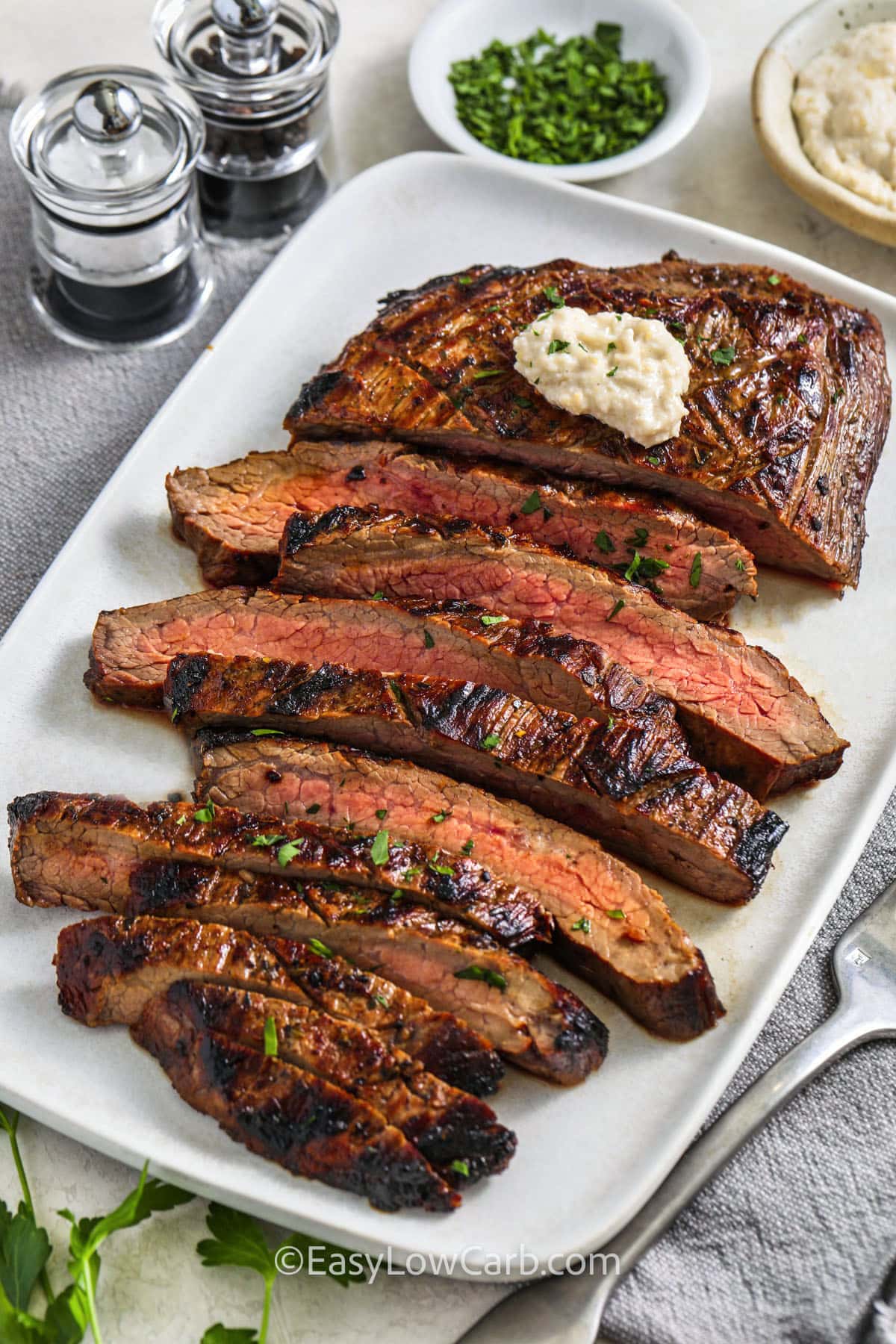 Grilled Flank Steak on a plate with horseradish