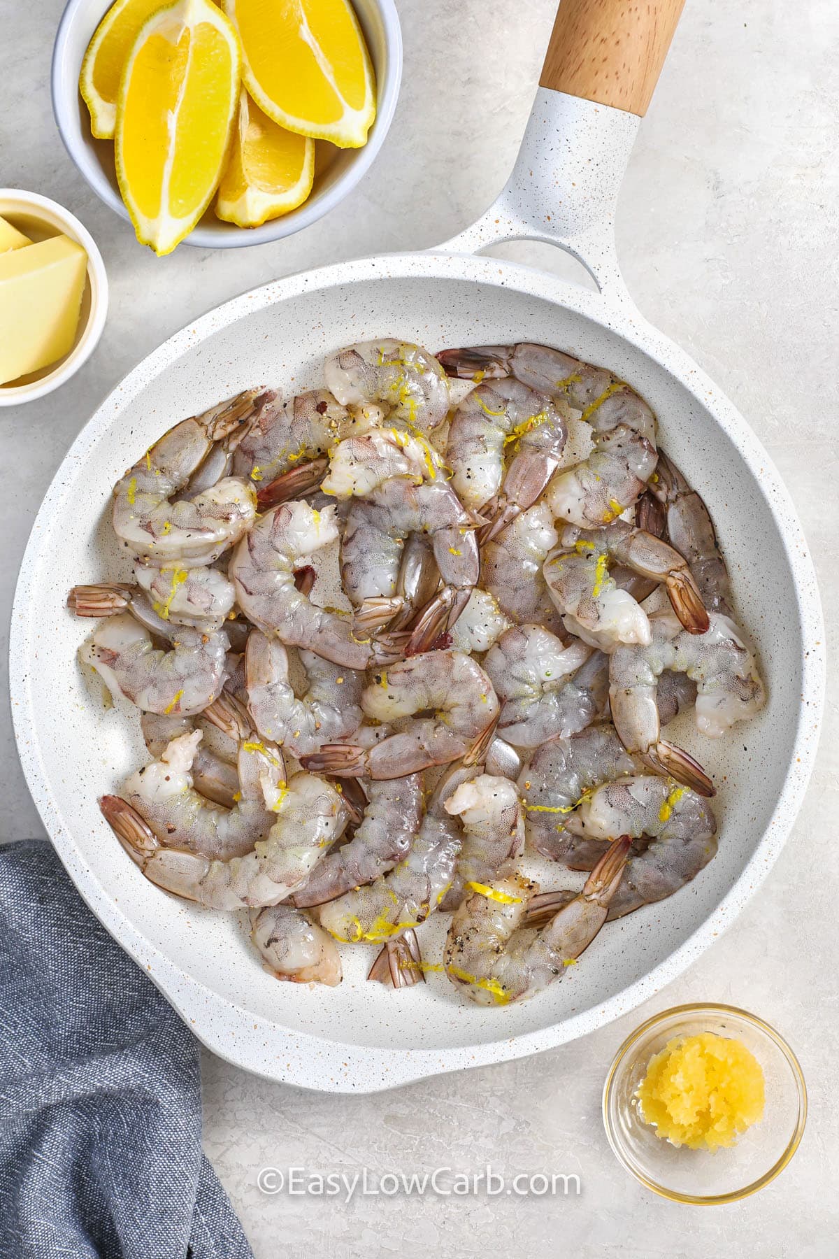 adding shrimp with lemon zest and oil to pan to make Lemon Garlic Shrimp