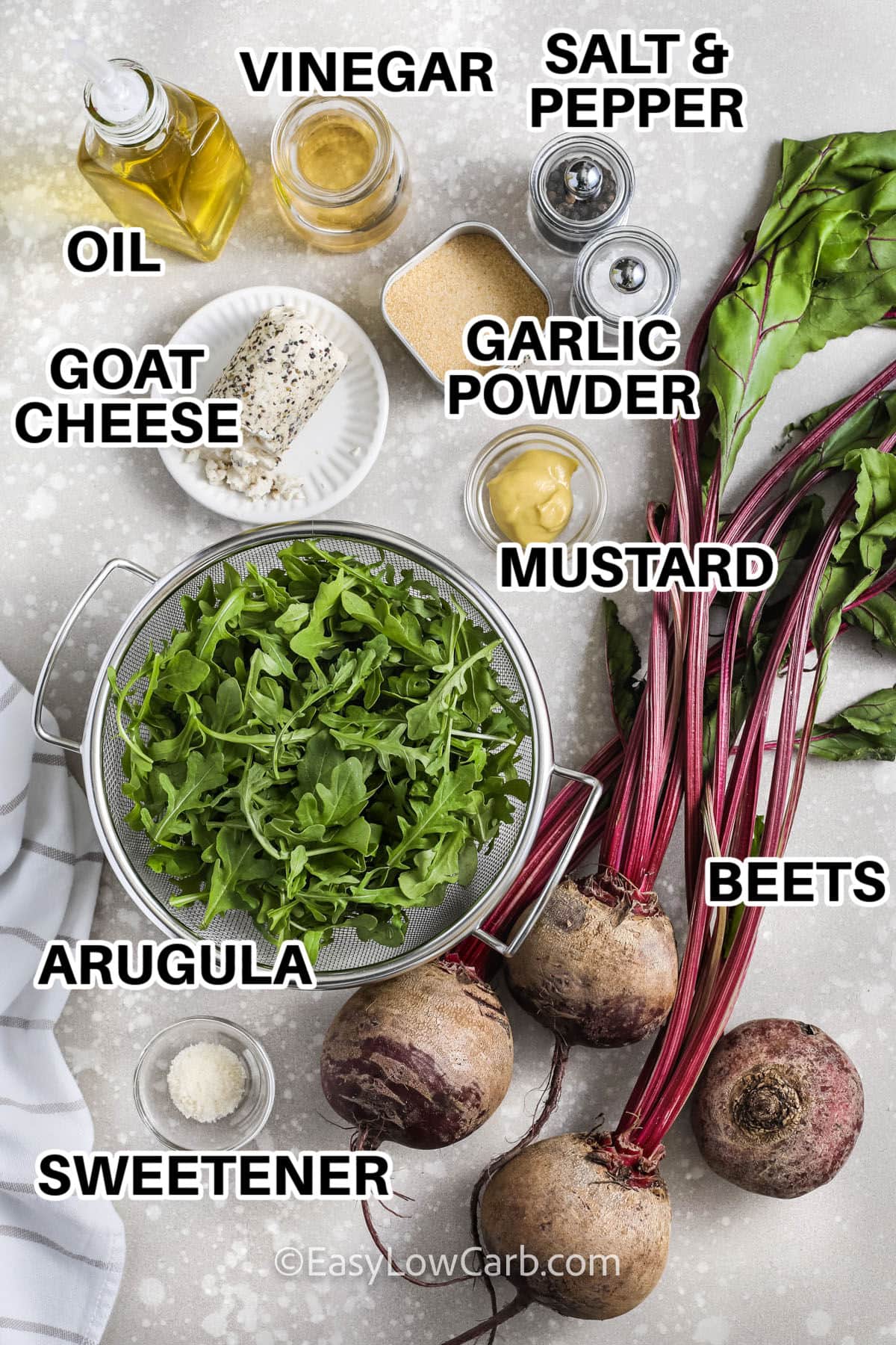 oil , vinegar , goat cheese , garlic powder , mustard , beets , arugula , sweetener , salt and pepper with labels to make Roasted Beet Salad