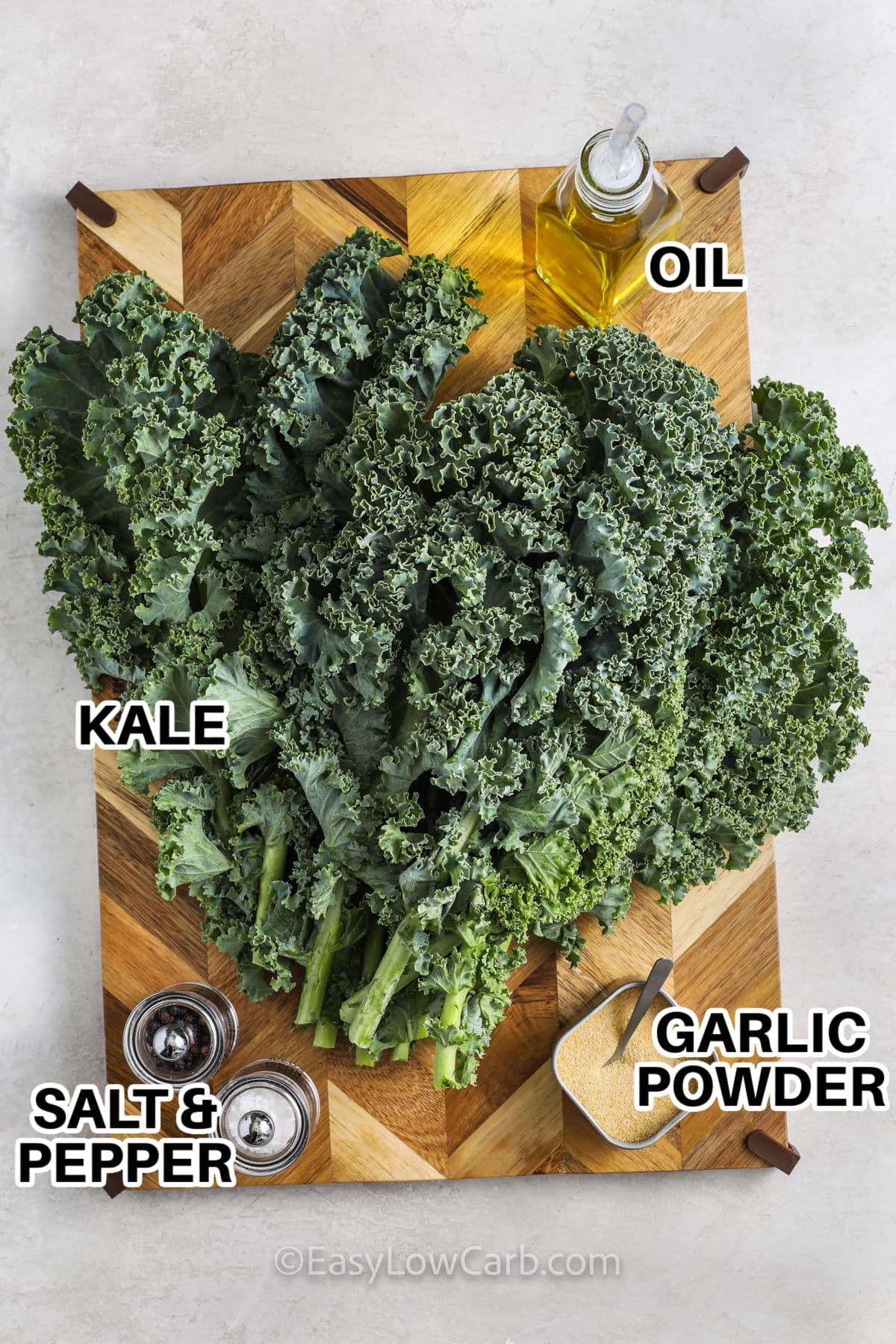 kale , oil , garlic powder , salt and pepper with labels to make Roasted Kale