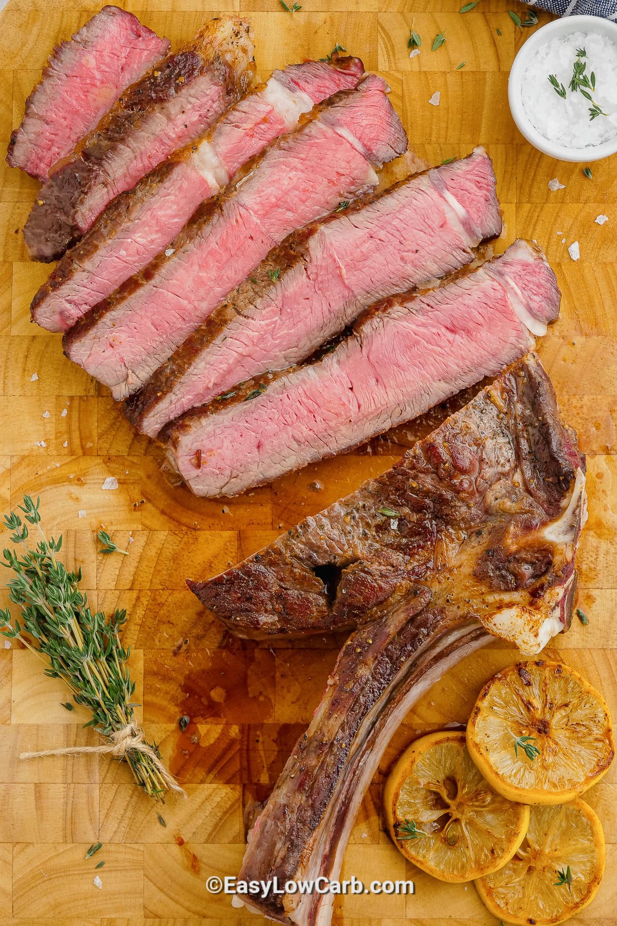 sliced oven baked steak on a plate on a cutting board