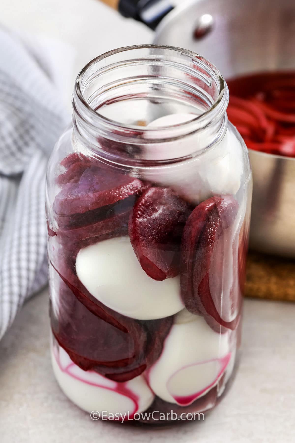 adding ingredients to jar to make Pickled Eggs and Beets