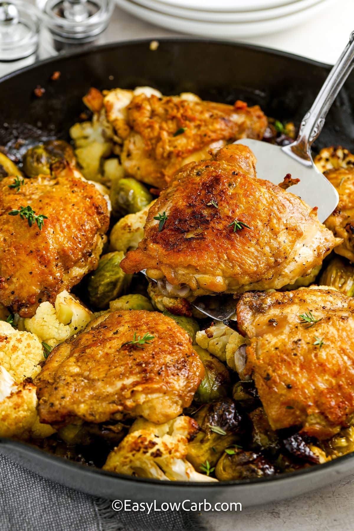 spatula scooping braised chicken thighs