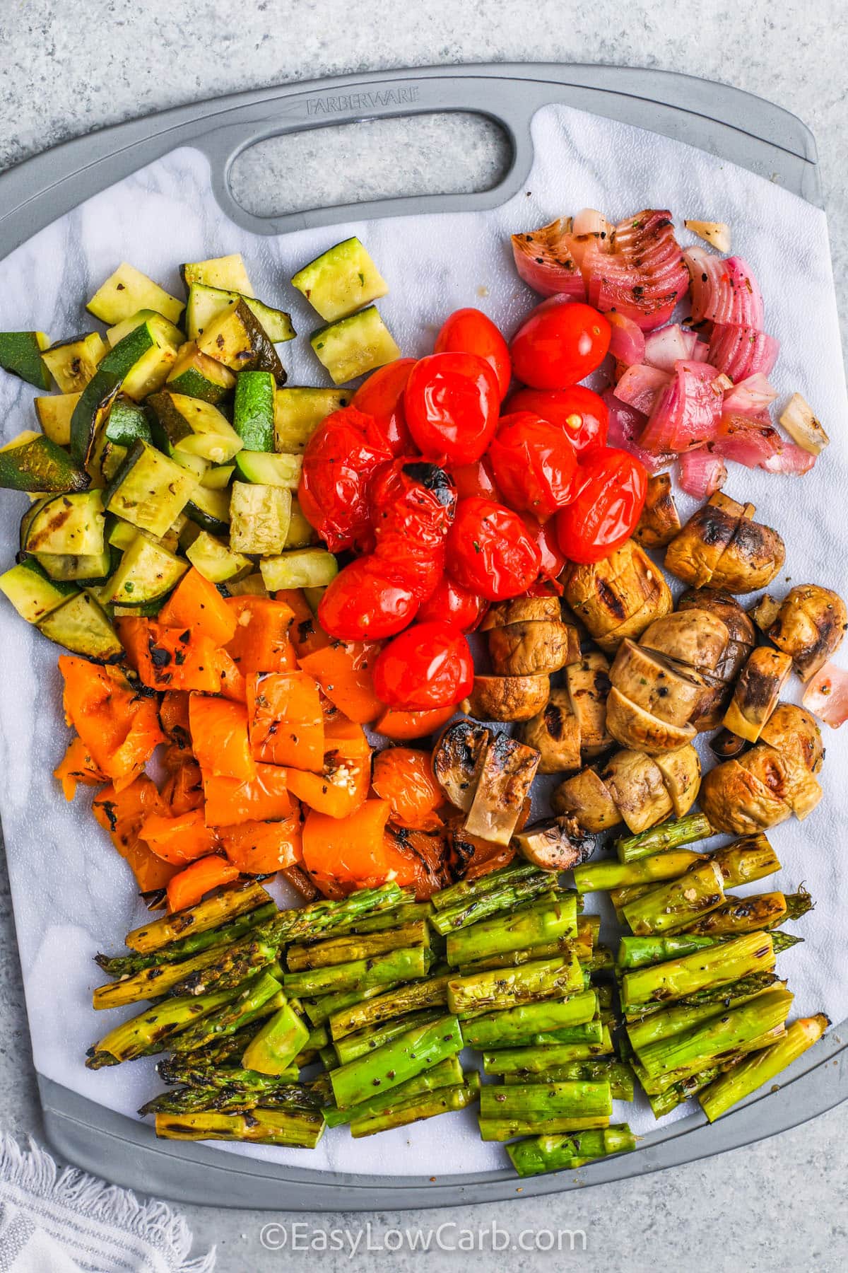 cutting up cooked vegetables to make Grilled Vegetable Salad