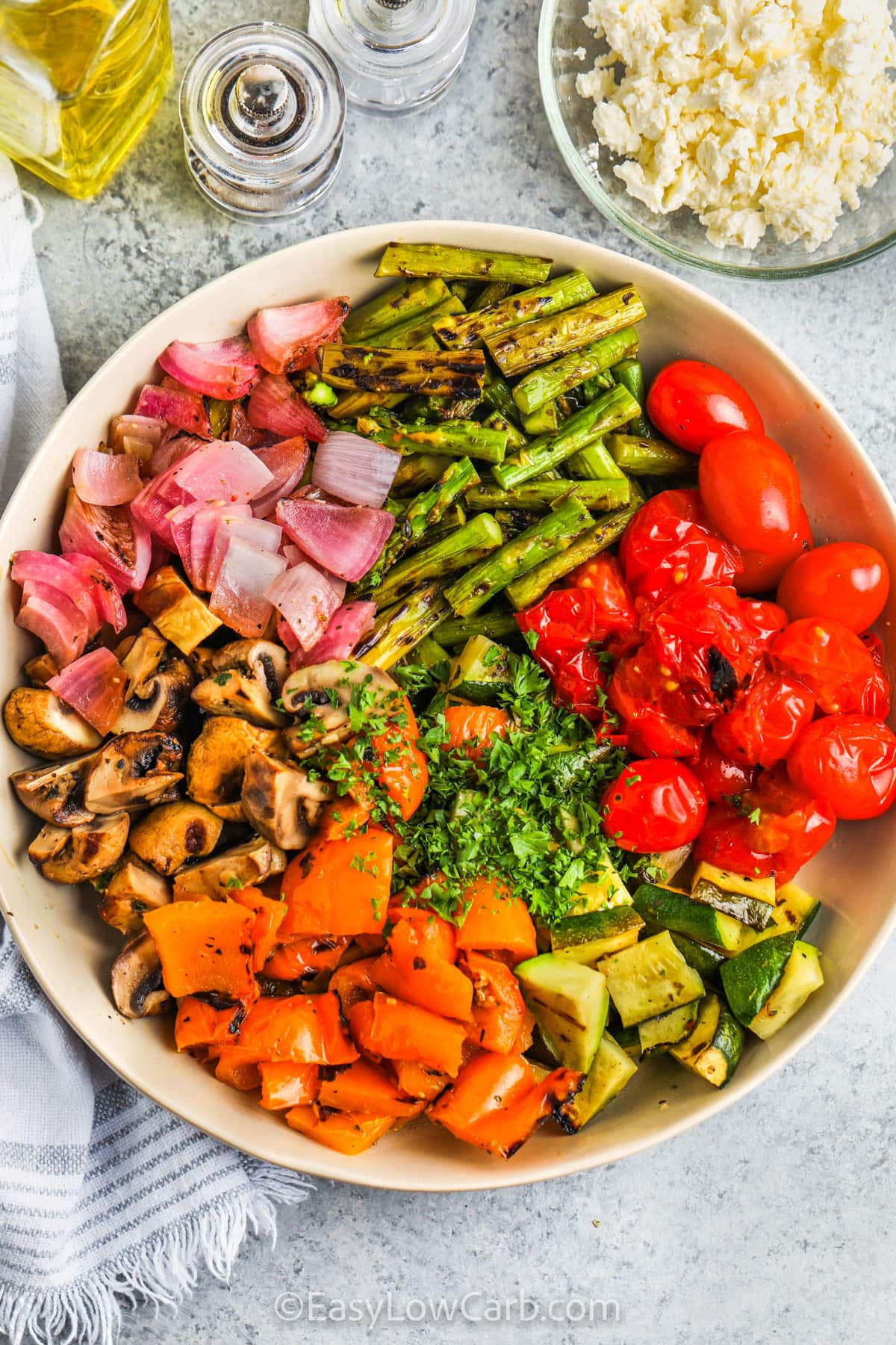 adding ingredients to bowl to make Grilled Vegetable Salad