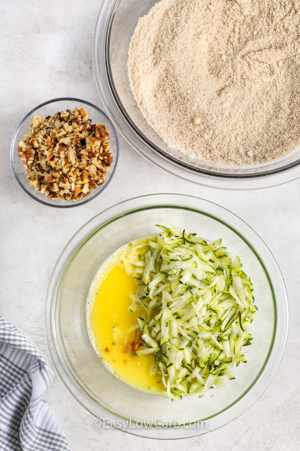 adding zucchini to wet ingredientst to make Keto Zucchini Bread