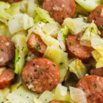 Fried cabbage and sausage recipe in a bowl with a title