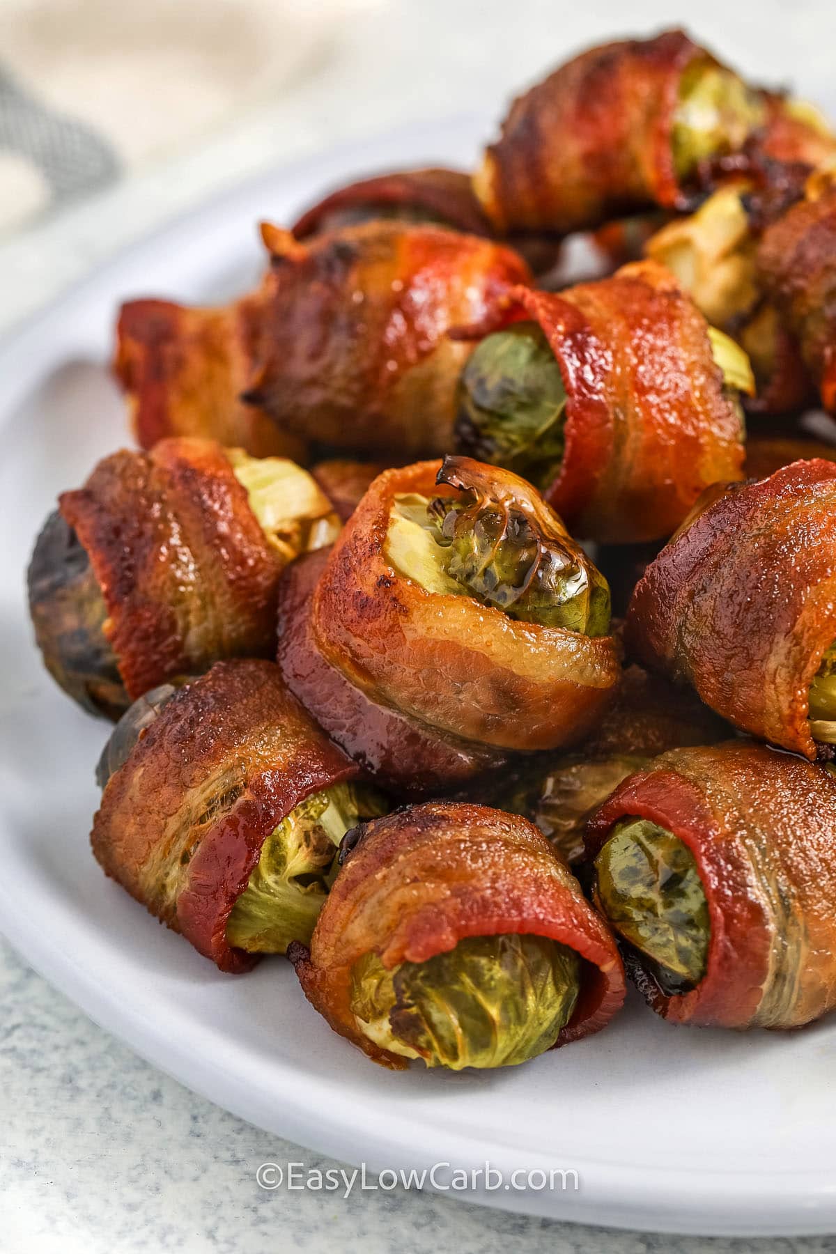 closeup of bacon wrapped brussel sprouts on a plate