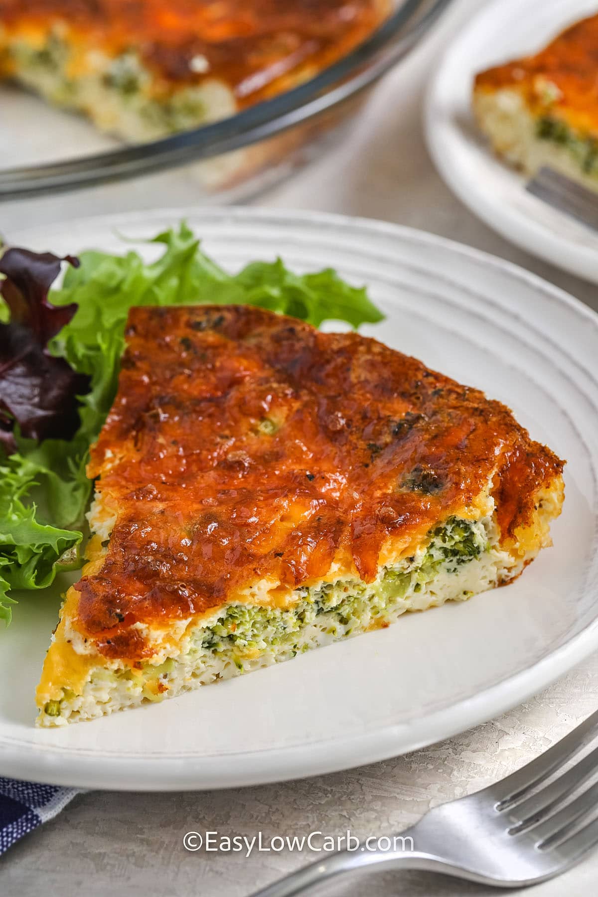 a serving of broccoli cheese quiche on a plate