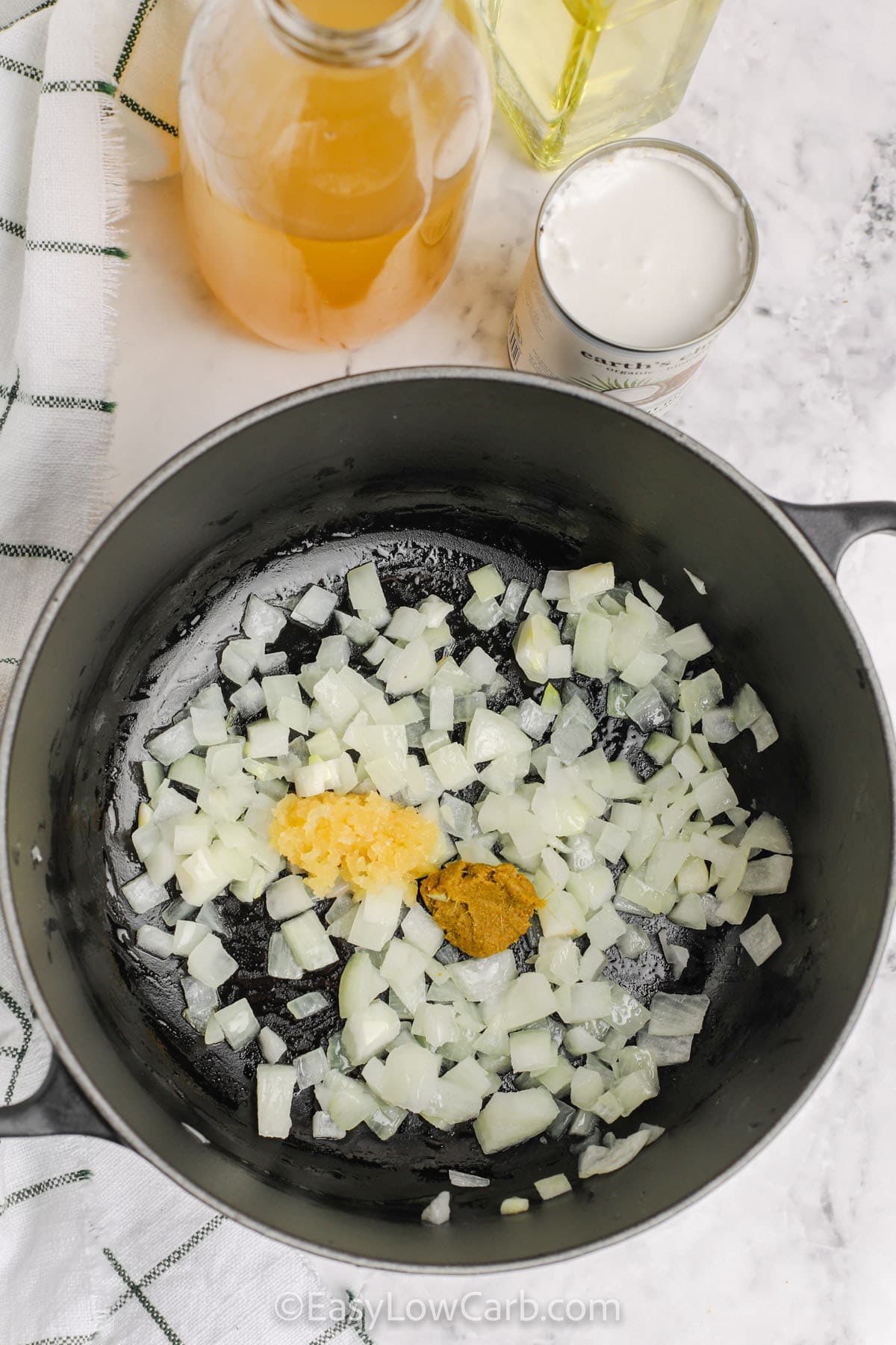 cooking onion with garlic and curry paste to make Curried Cauliflower Soup