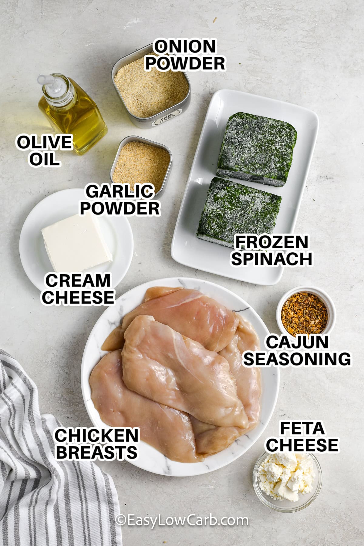 ingredients to make spinach stuffed chicken breasts labeled: onions powder, olive oil, garlic powder, frozen spinach, cream cheese, cajun seasoning, chicken breasts, and feta cheese.