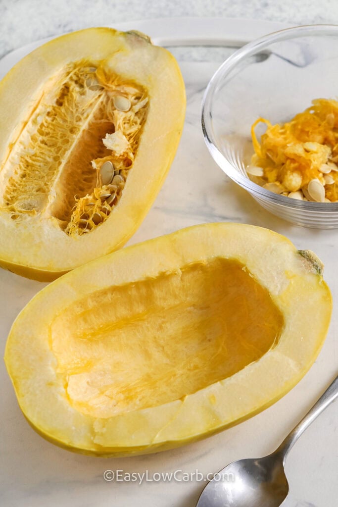 scooping out Squash seeds and guts to make Microwave Spaghetti Squash