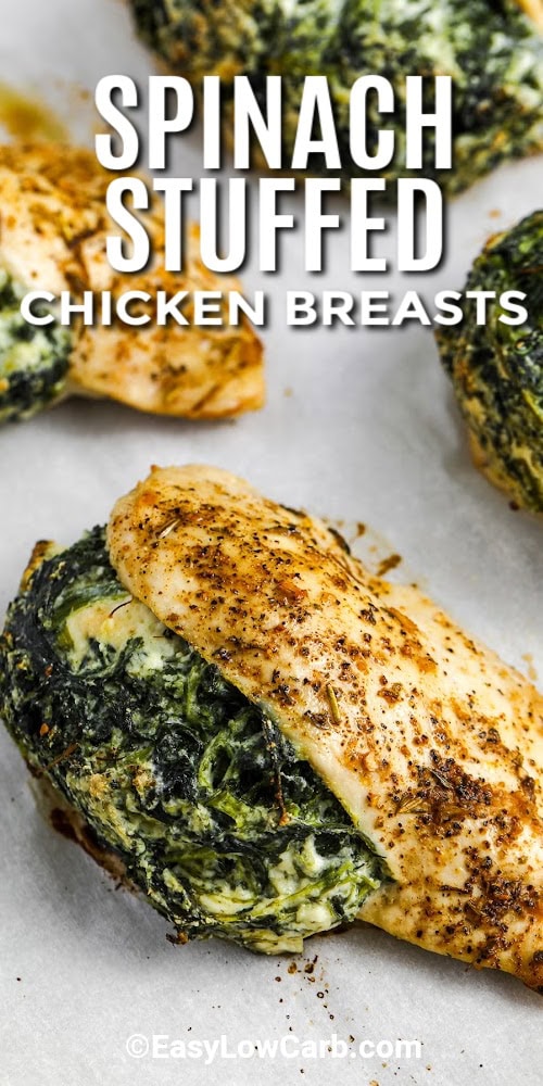 Spinach stuffed chicken breasts cooked on a baking tray with a title