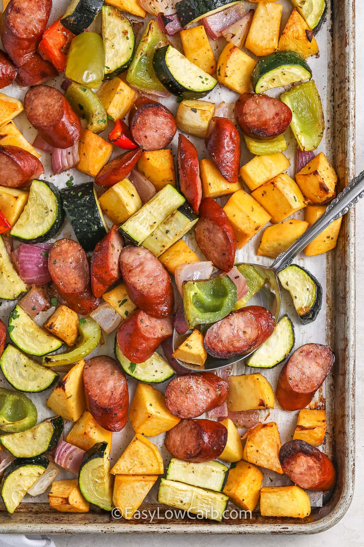 Sheet Pan Sausage and Vegetables with a spoon