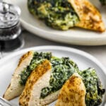 spinach stuffed chicken breast sliced on a plate