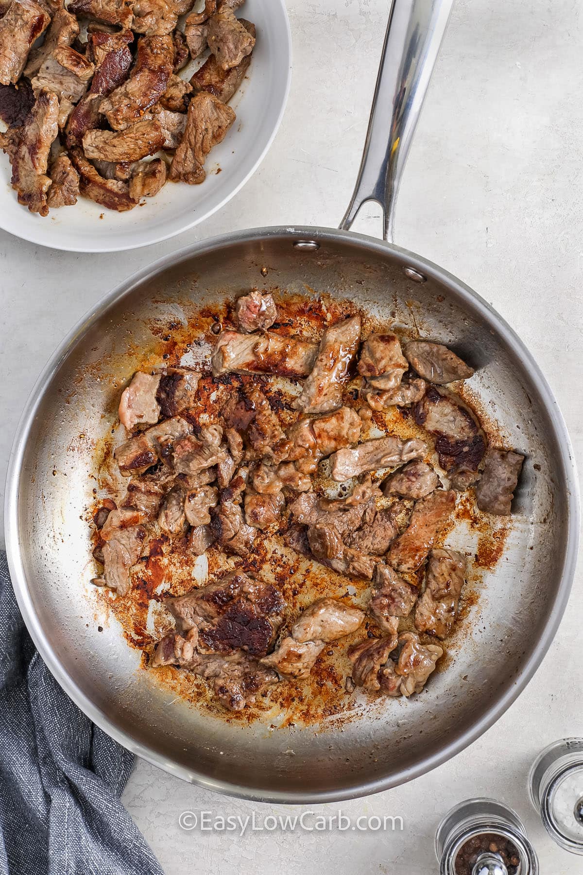 steak cooked in a pan for cheesesteak stuffed peppers