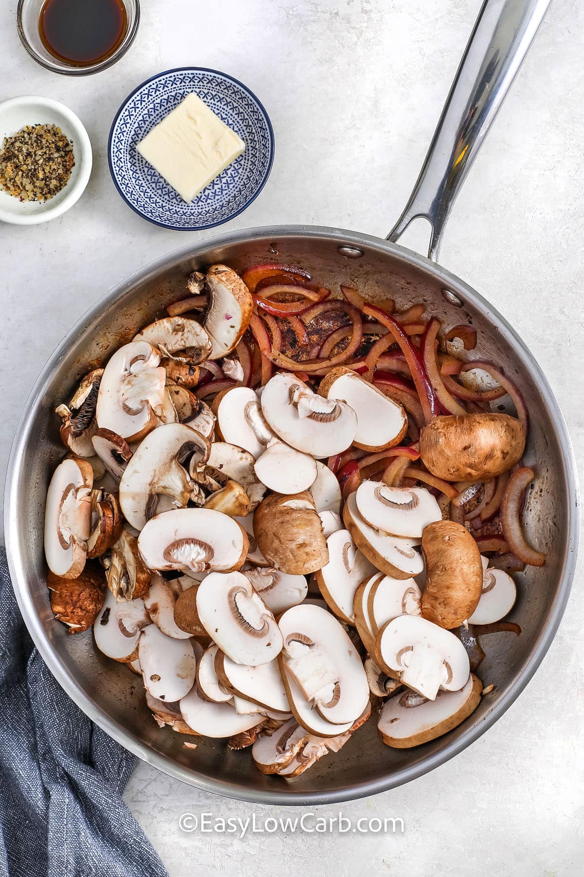 steak and mushrooms in a pan for making cheesesteak stuffed peppers