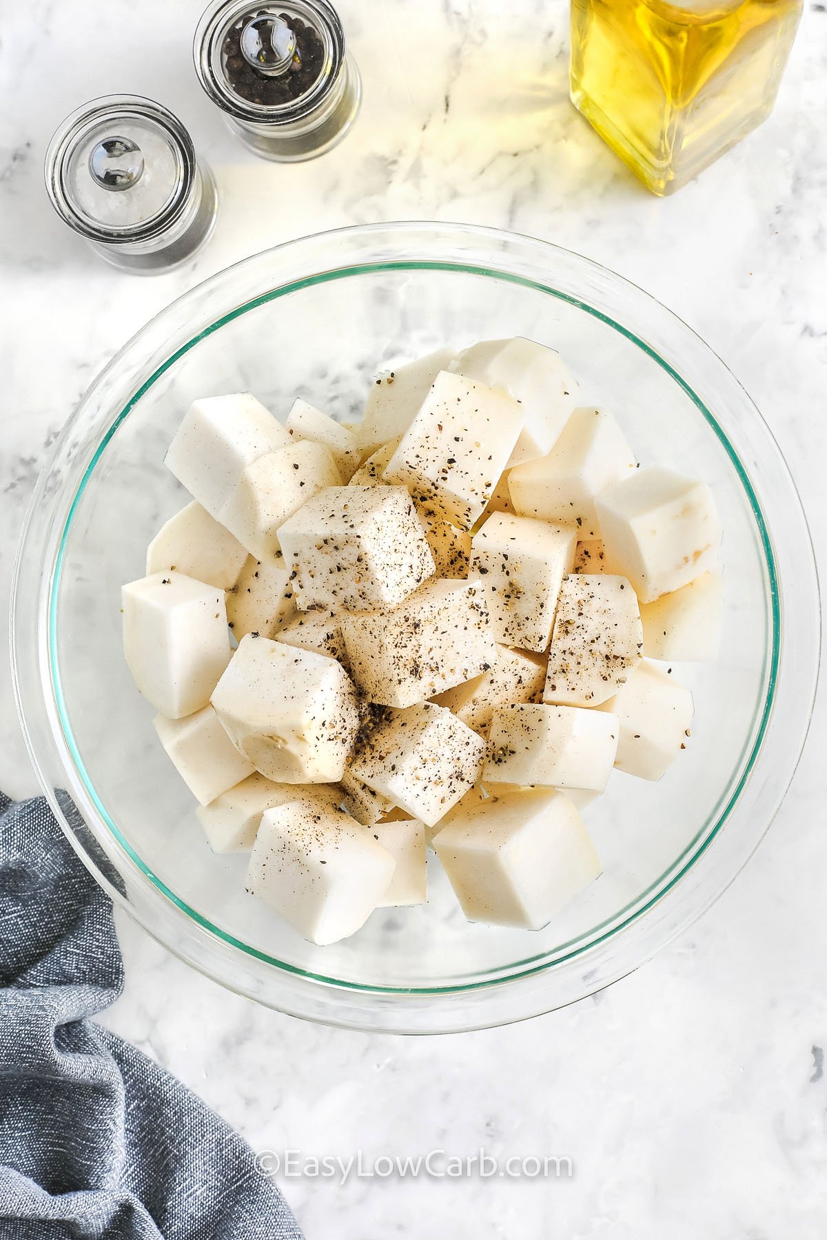 seasoned pieces of turnip in a bowl to make Roasted Turnips