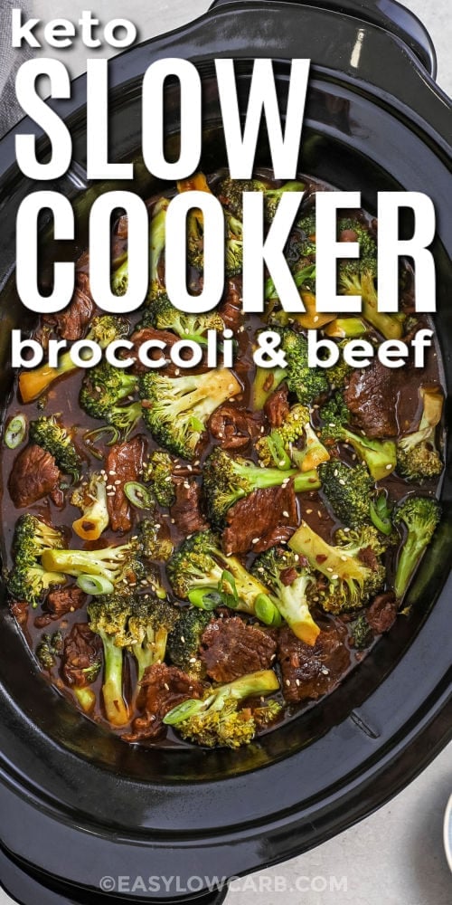 Looking down on Slow cooker beef and broccoli cooking in a black crock with writing.