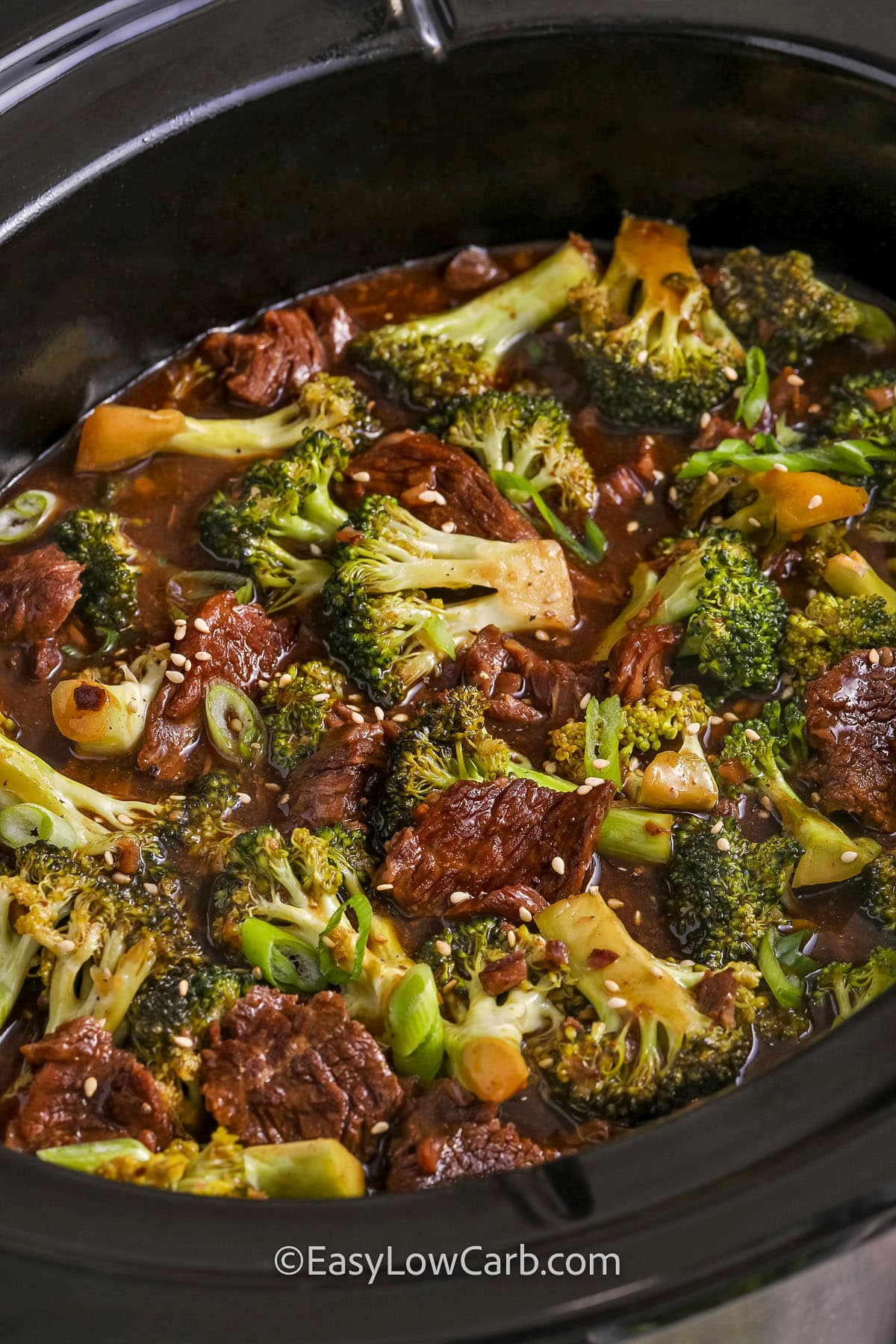 A crock pot filled with slow cooker beef and broccoli