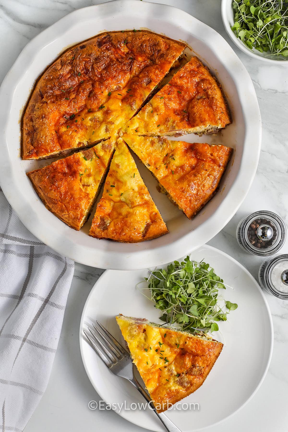 Crustless Ham and Cheese Quiche with a piece taken out on a plate