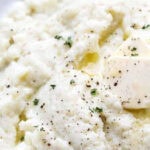 mashed cauliflower in a bowl with text