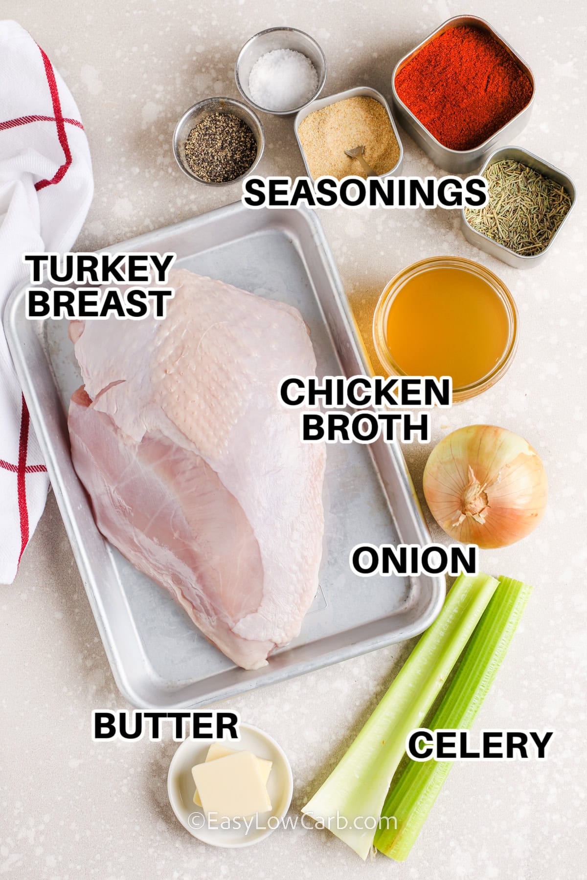 ingredients assembled to make crock pot turkey breast, including seasonings, onion, celery, turkey breast, and chicken broth