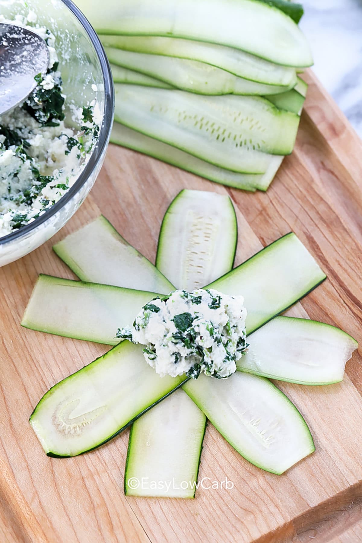 adding filling to zucchini strips to make Zucchini Ravioli