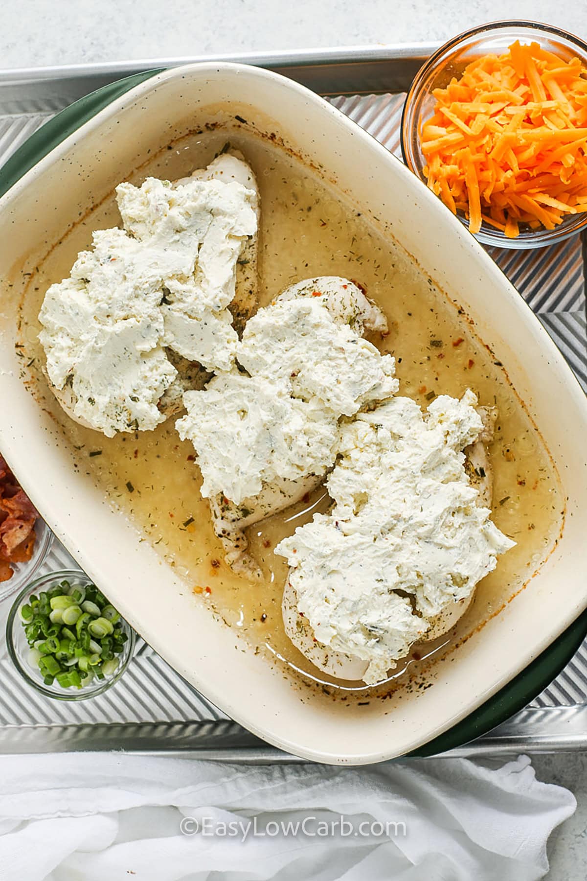 adding cream cheese to chicken to make Baked Chicken Crack Recipe
