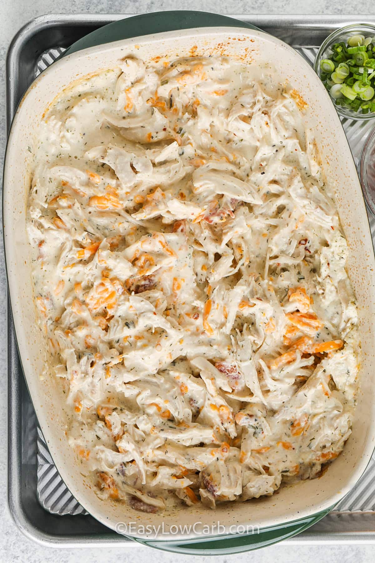 mixing all ingredients together in dish to make Baked Chicken Crack Recipe