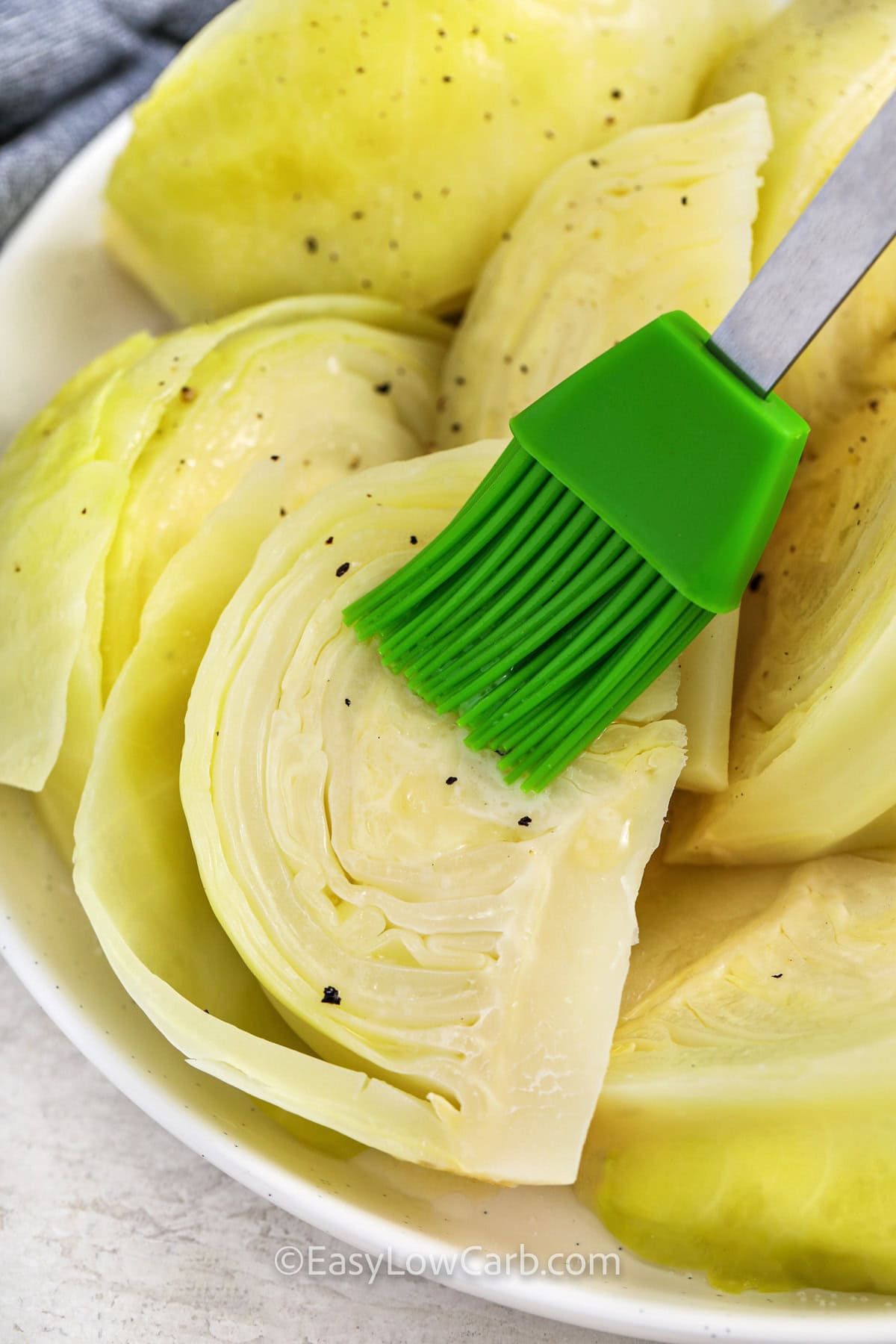cabbage being brushed with butter or oil