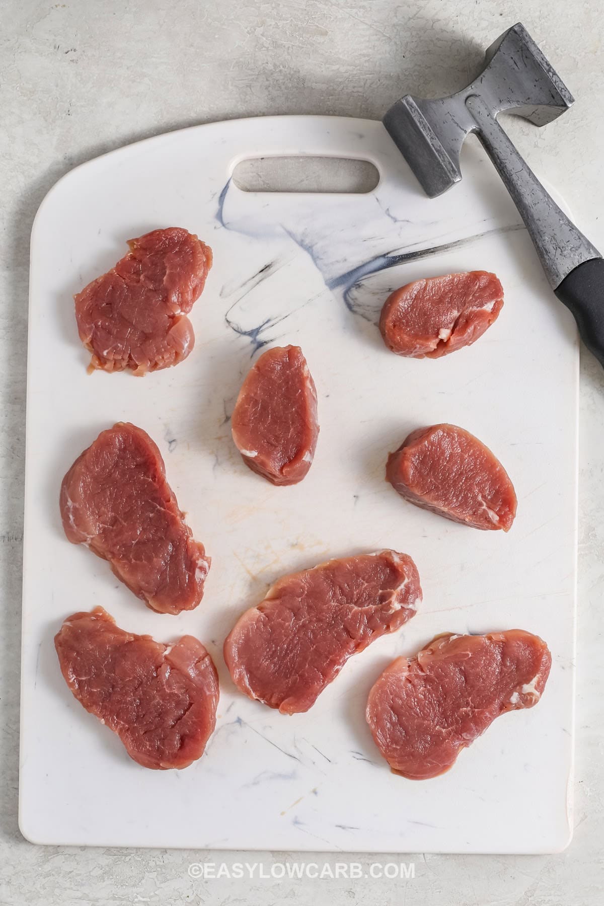 sliced pork with a hammer to make Creamy Dijon Pork Tenderloin Medallions