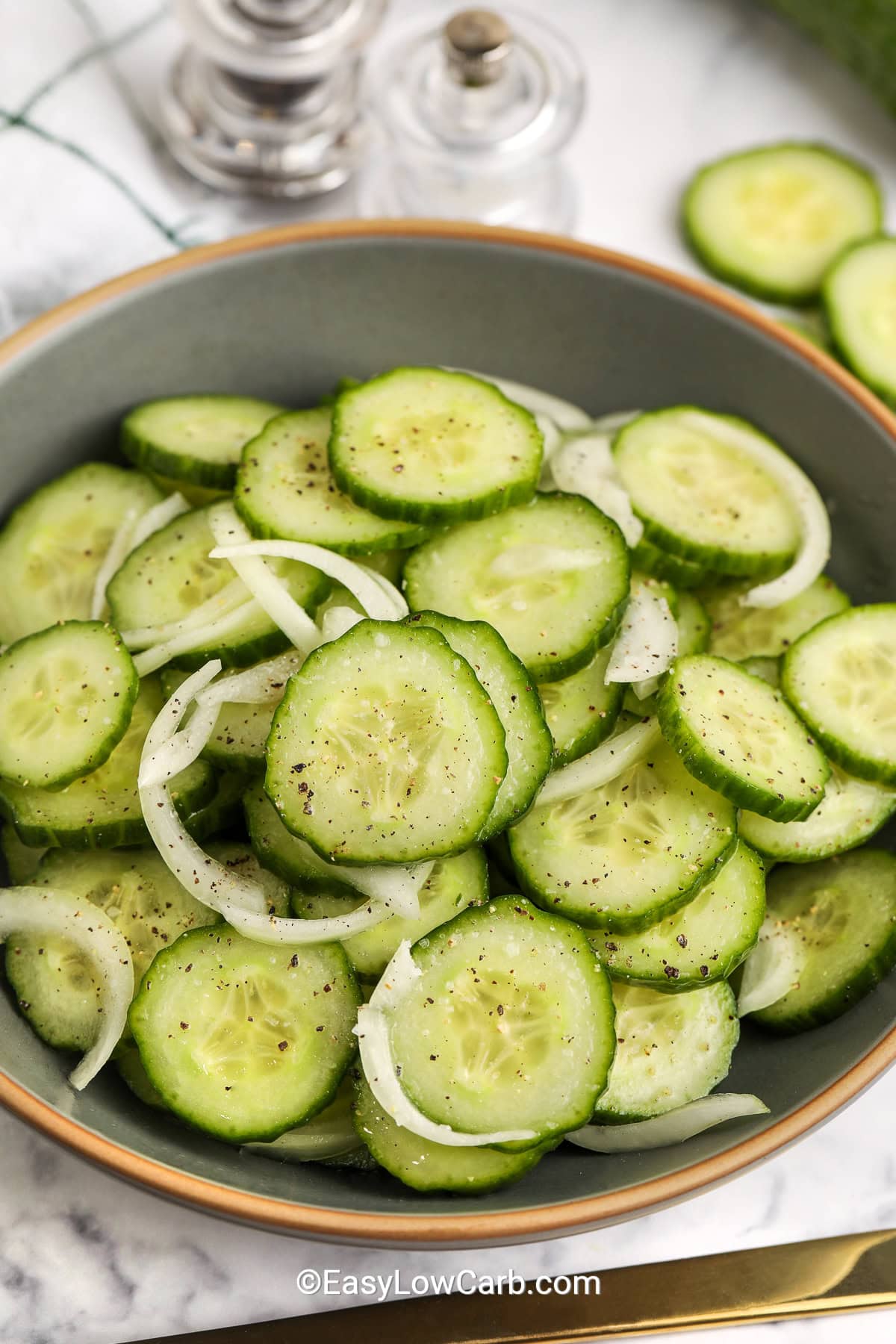 A bowl of cucumber and onion salad.