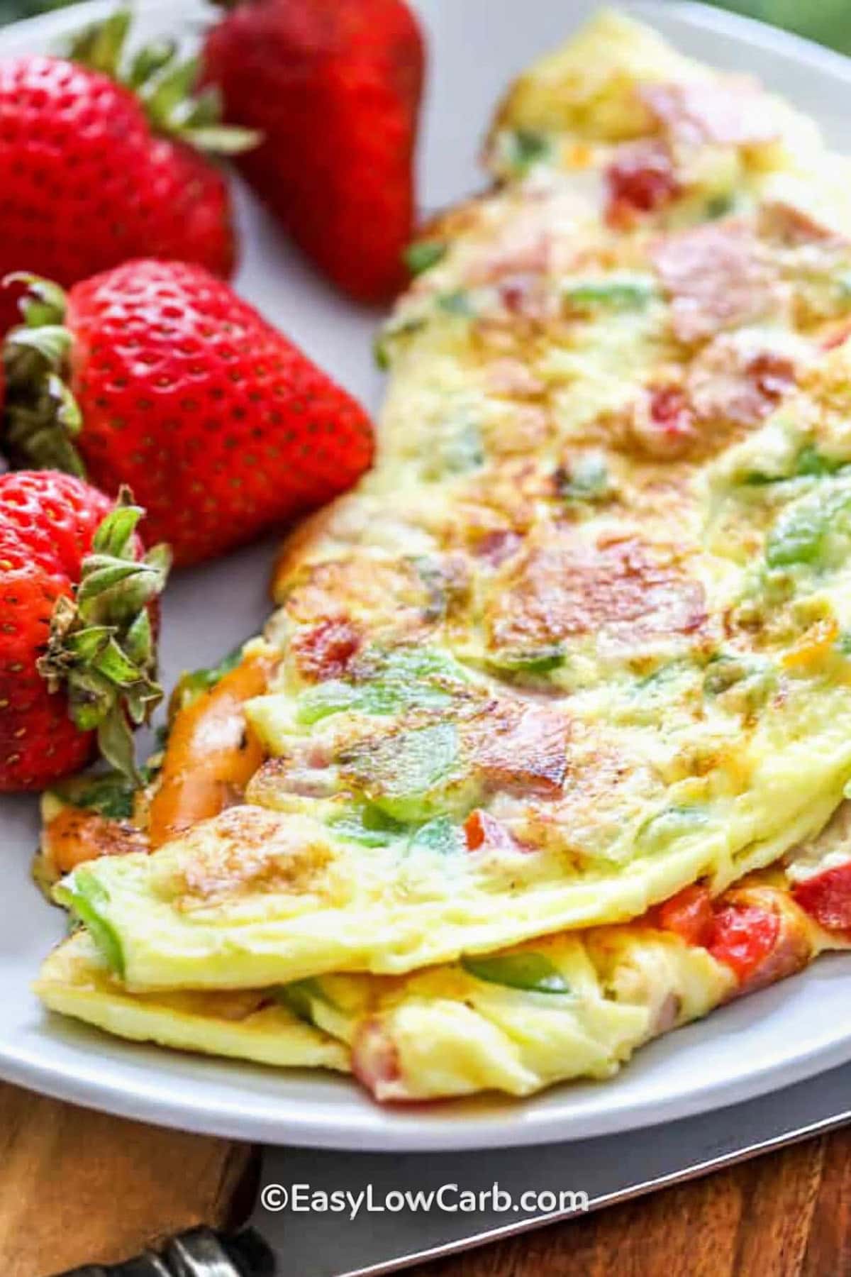 close up of Denver Omelette Recipe on a plate with strawberries