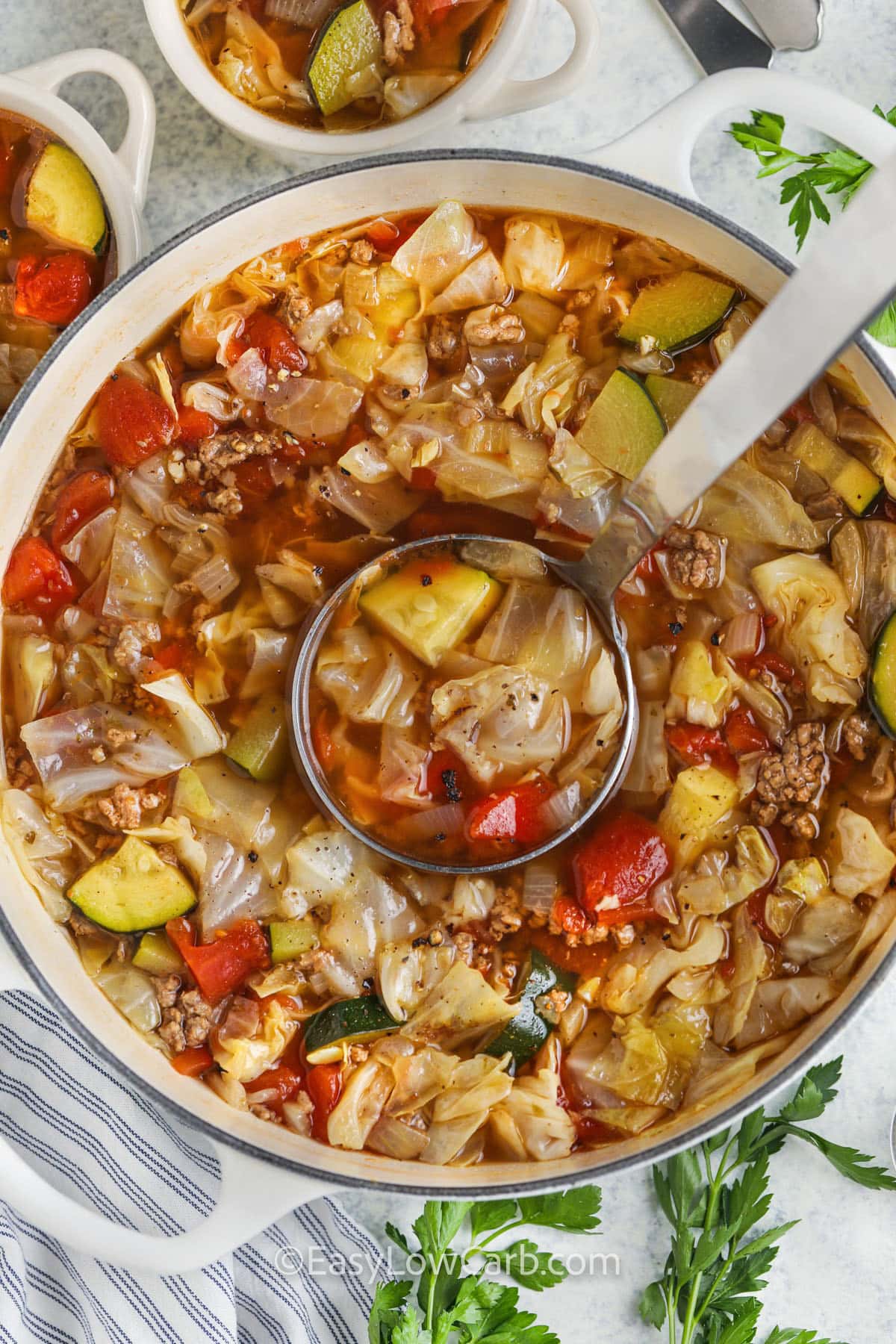 pot full of Ground Beef Vegetable Soup with a spoon