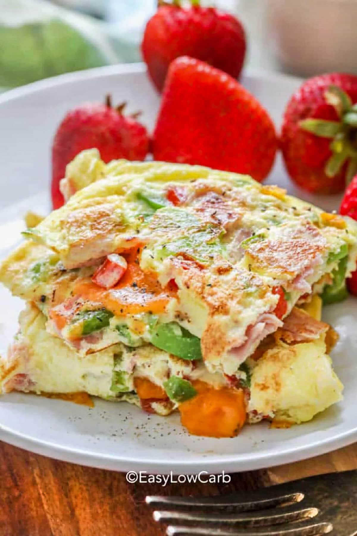 stack of cooked Denver Omelette Recipe with strawberries on a plate