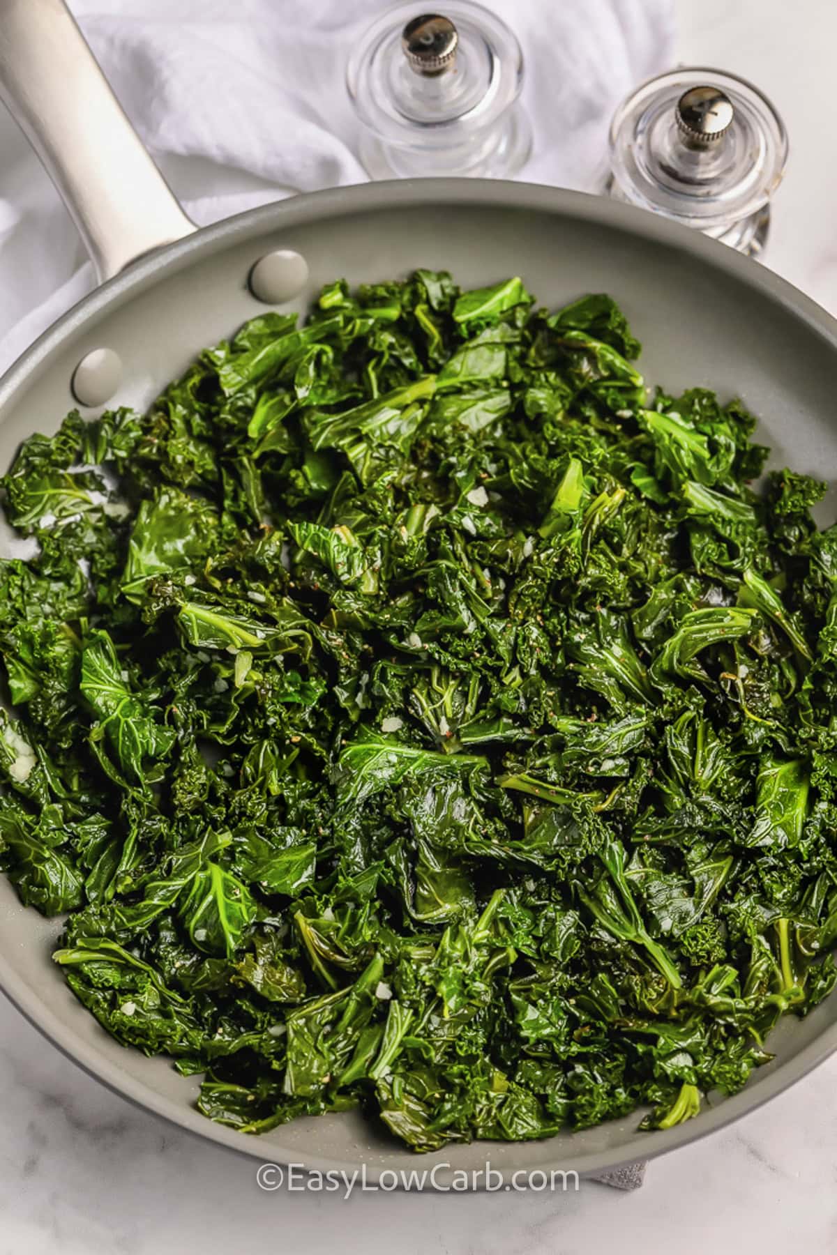 cooking kale in pan to make Sautéed Kale