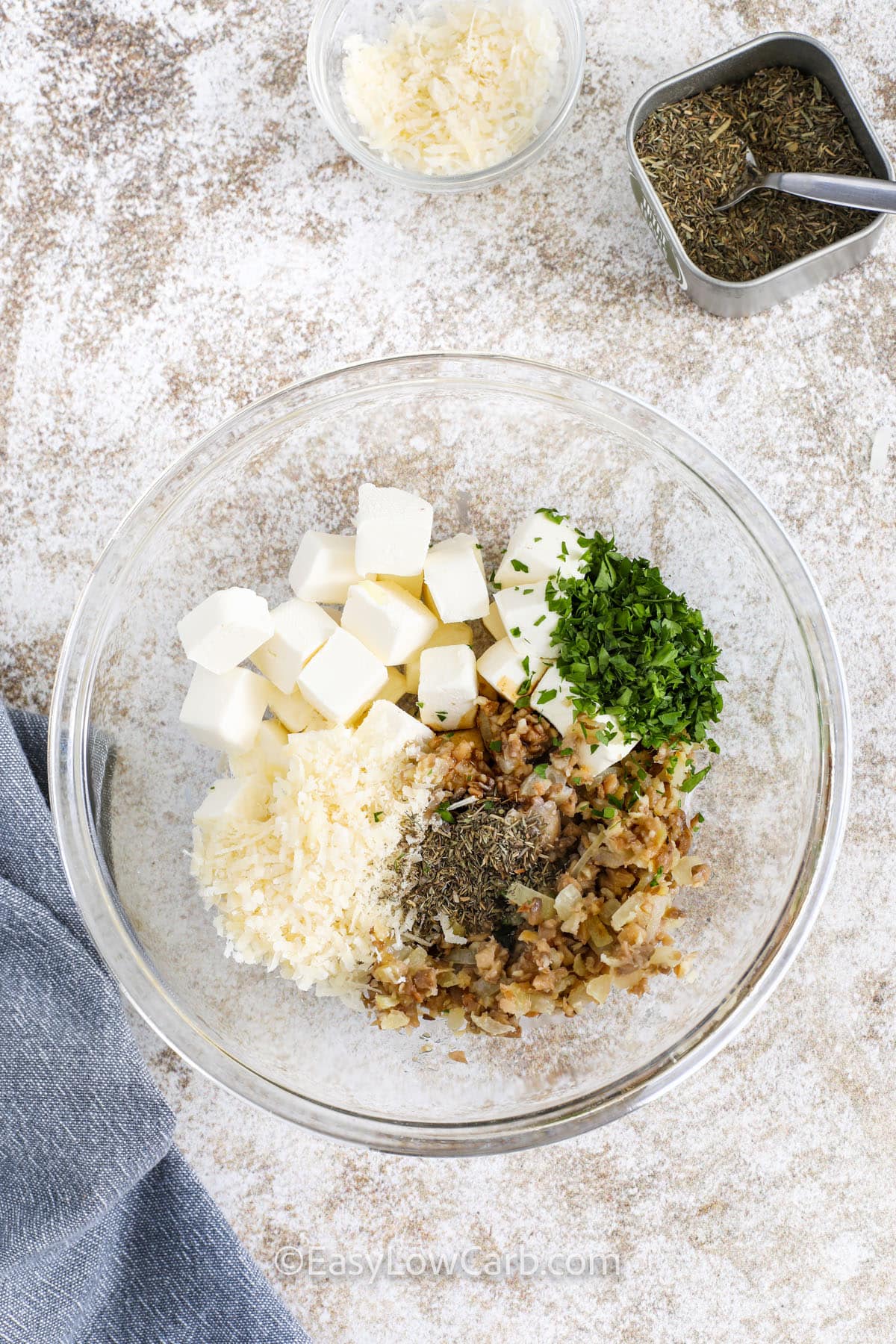 adding ingredients together in bowl to make Air Fryer Stuffed Mushrooms