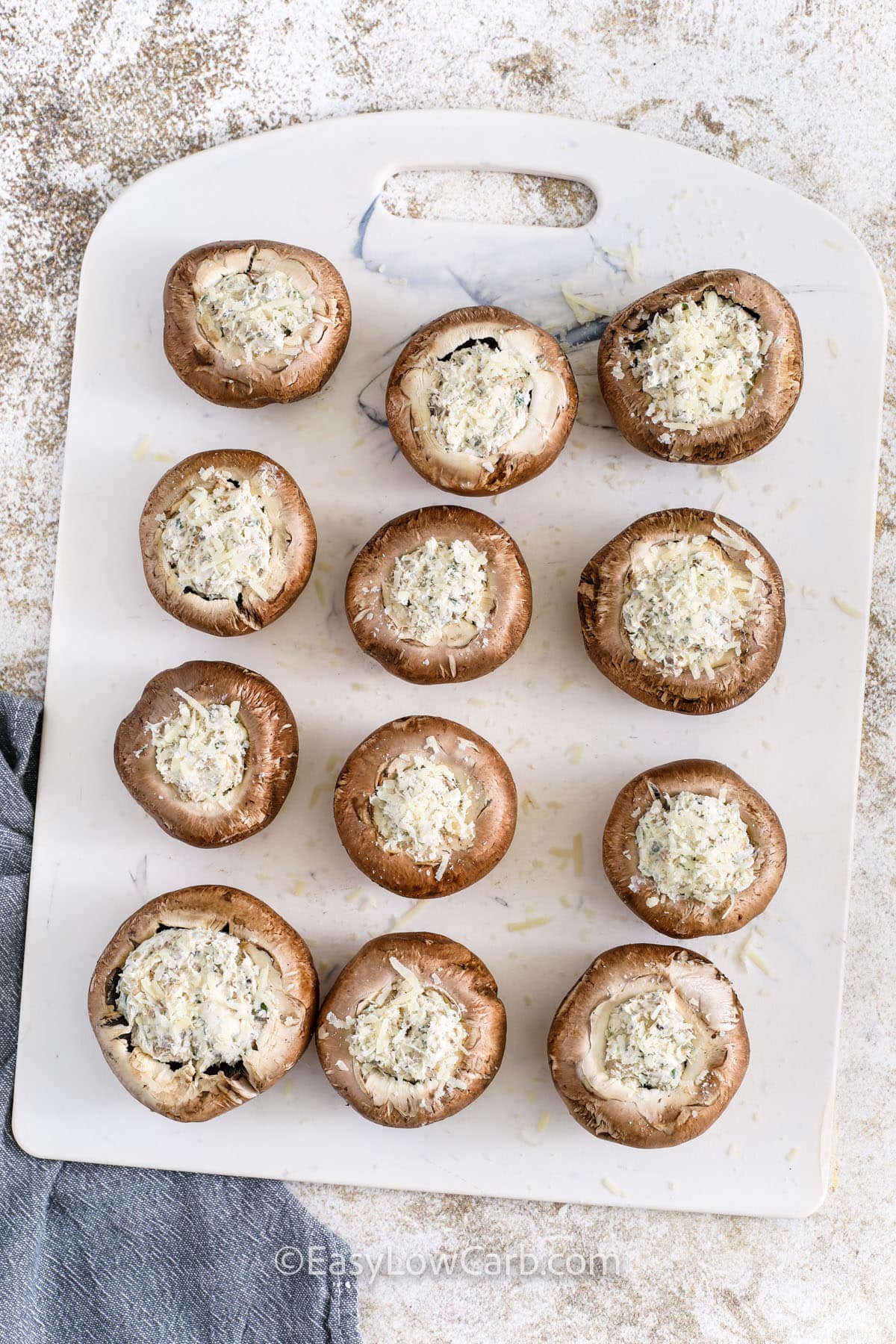 adding filling to mushrooms to make Air Fryer Stuffed Mushrooms