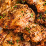 close up of juicy grilled Chicken Thighs Recipe with writing.