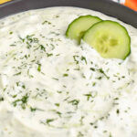 close up of Homemade Tzatziki with vegetables and a title