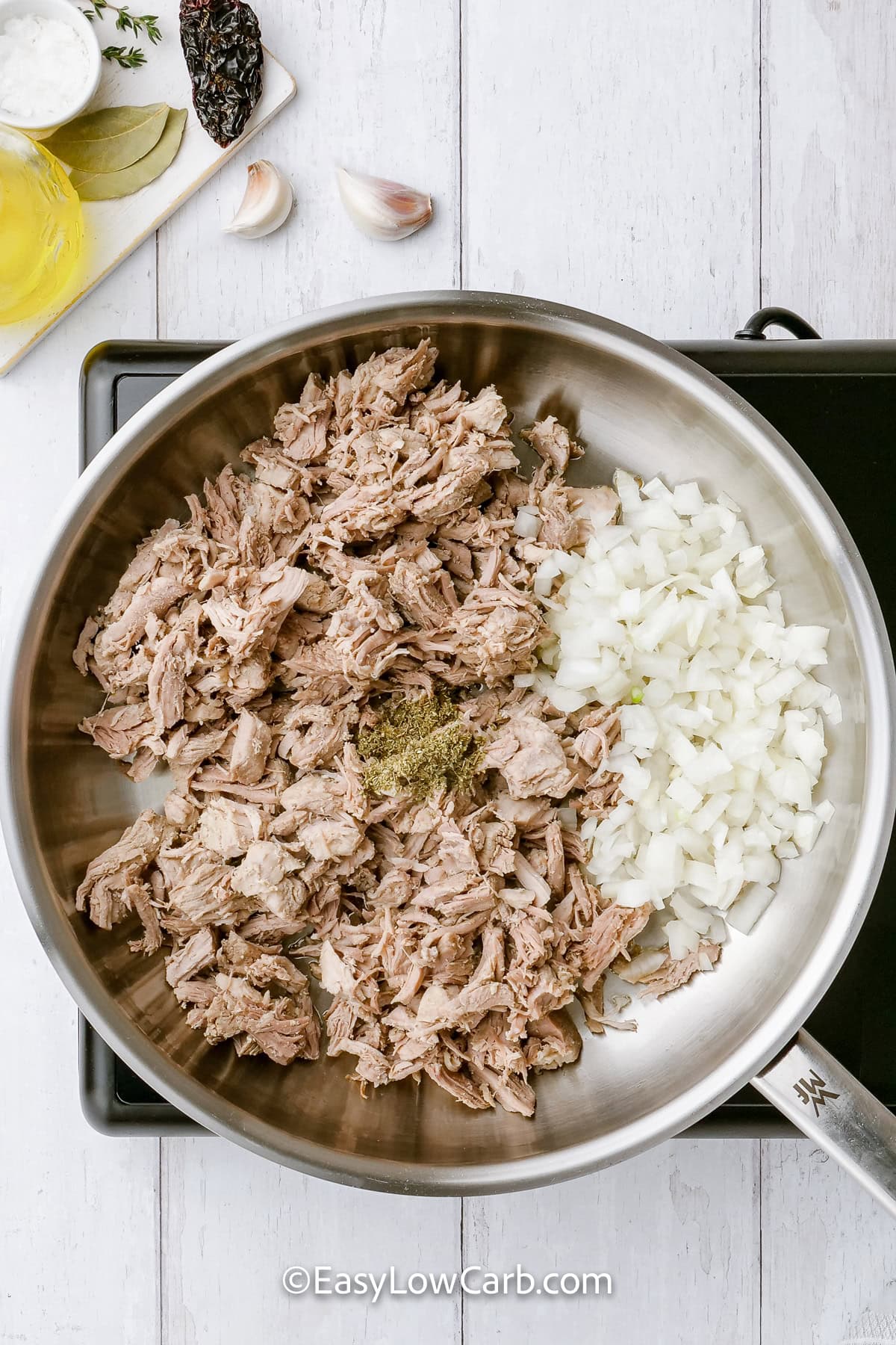 adding pork with onion and seasonings to make Shredded Pork Tacos