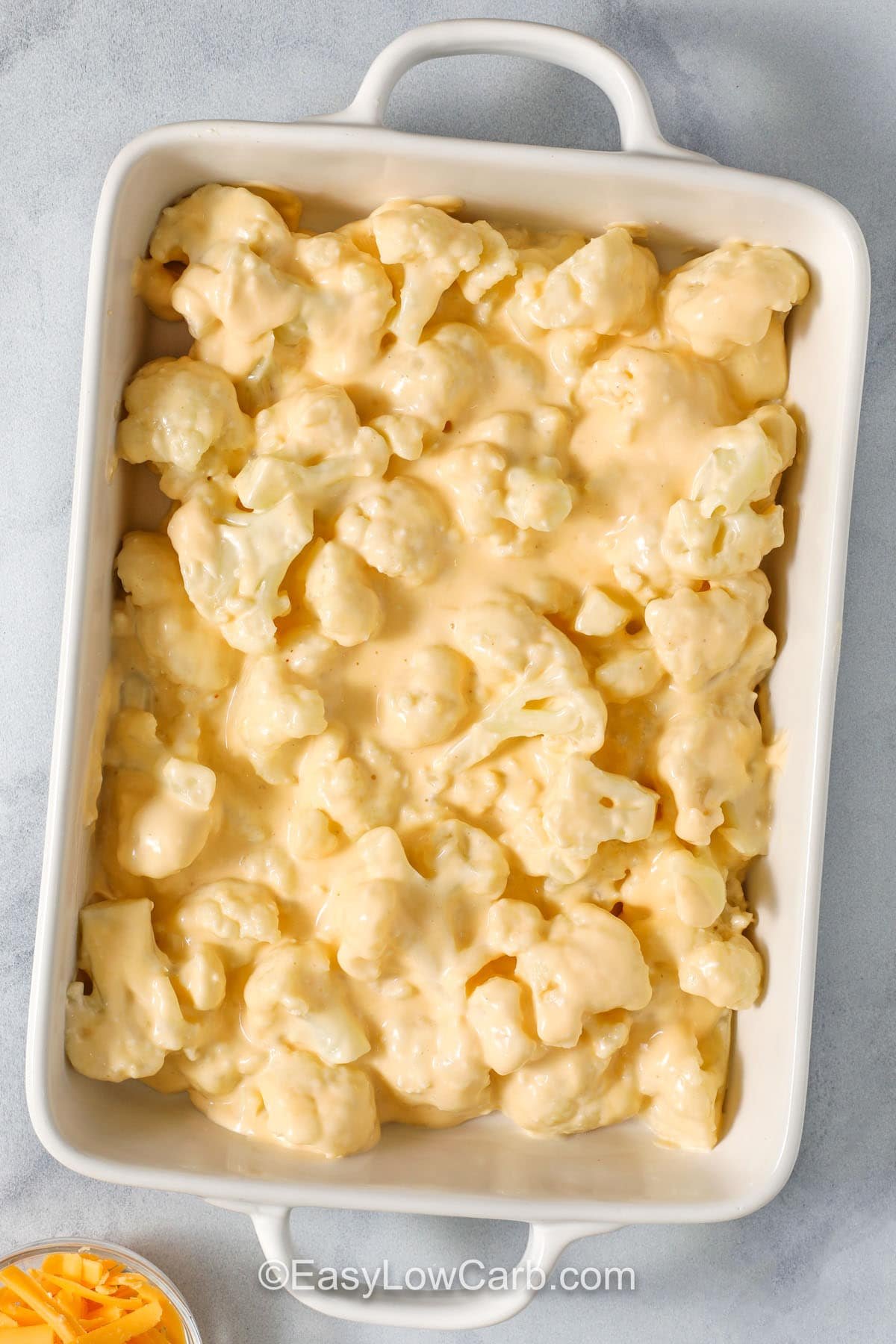 adding cauliflower mixture to dish to make Cheesy Cauliflower Casserole