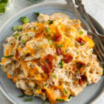crack chicken casserole on a plate topped with green onions