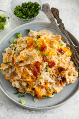 crack chicken casserole on a plate topped with green onions