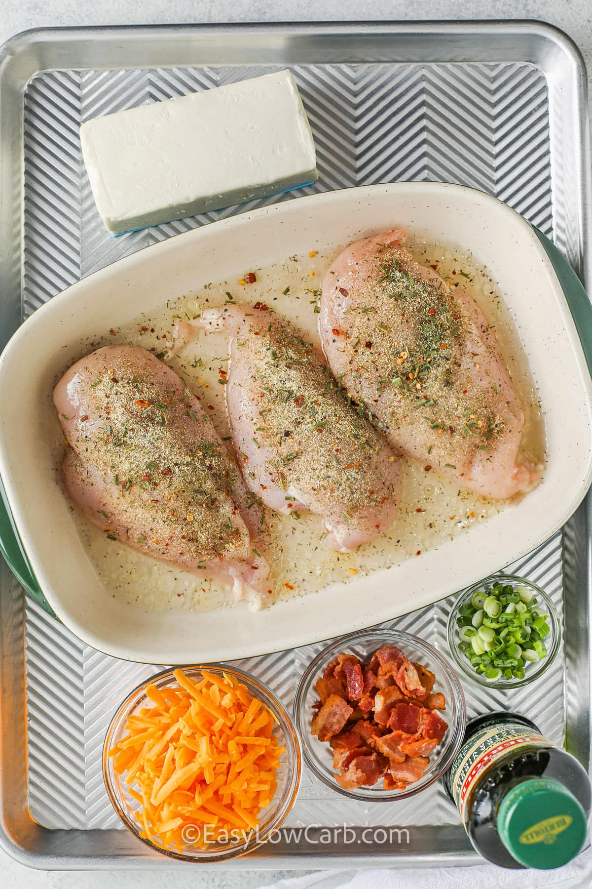 uncooked chicken breasts in a dish