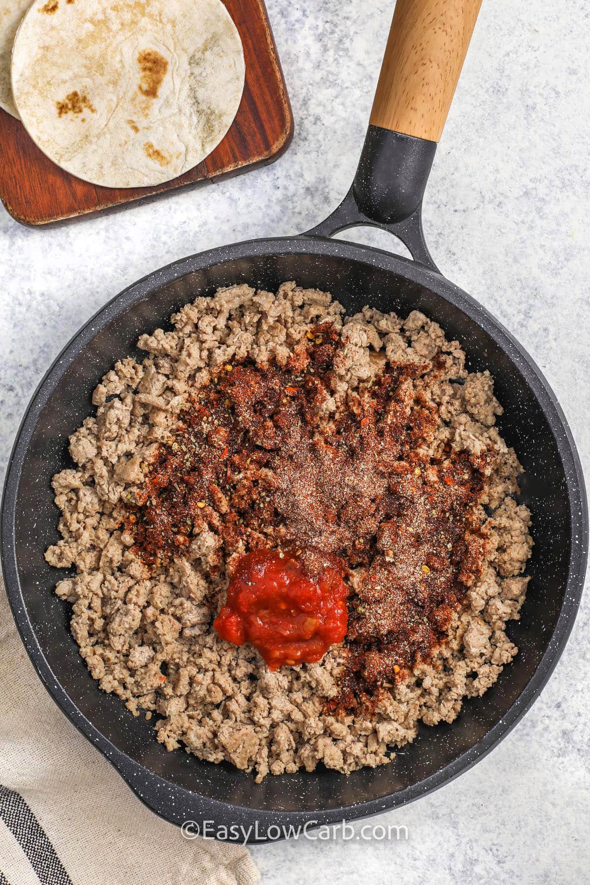 adding ingredients to make filling for Ground Turkey Tacos
